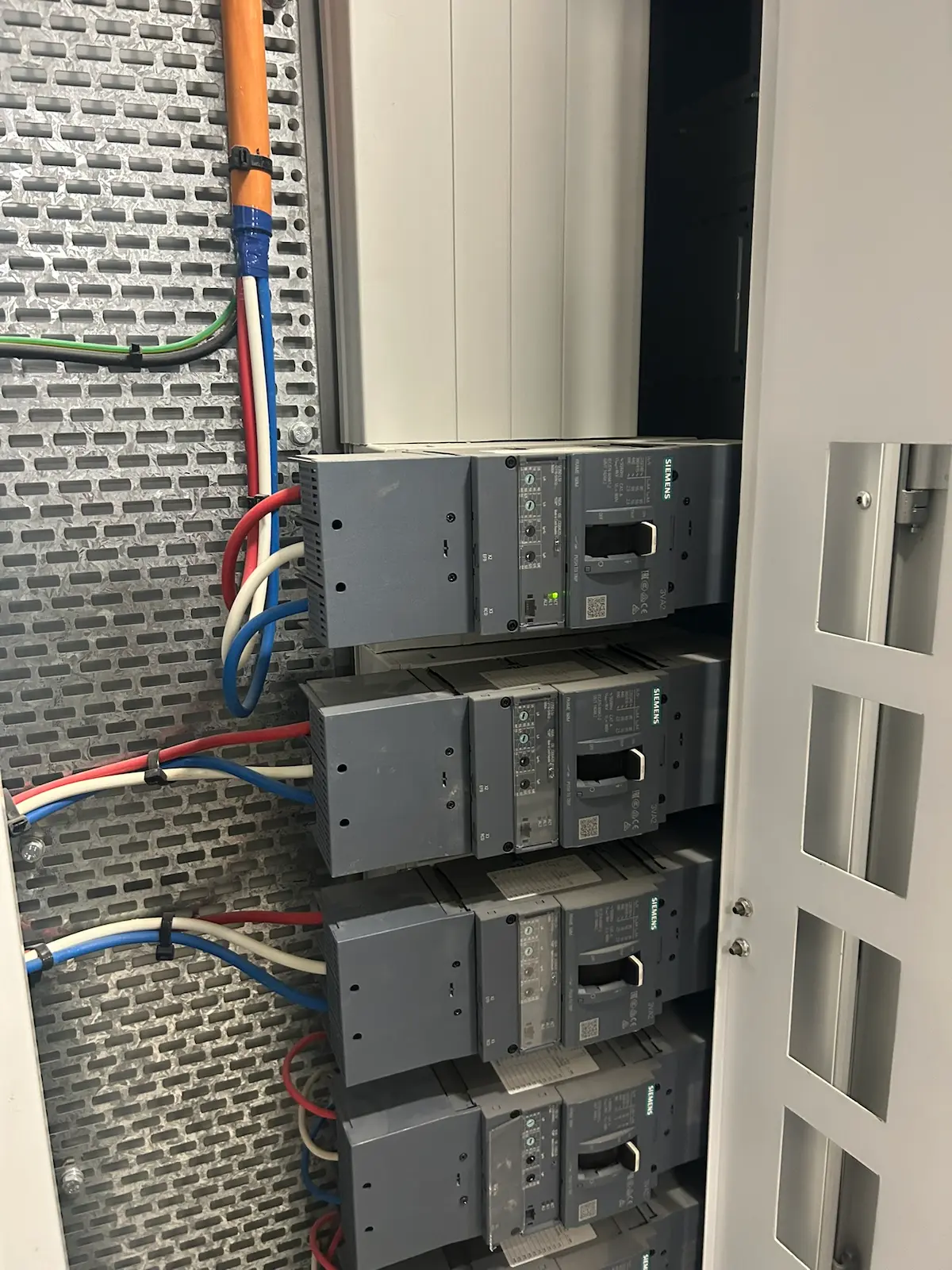 Row of siemens moulded case circuit breakers bottom fed in a commercial switchboard