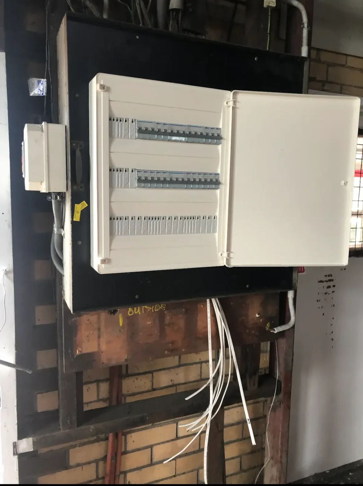 Twin din rail enclosure mounted on a brick wall