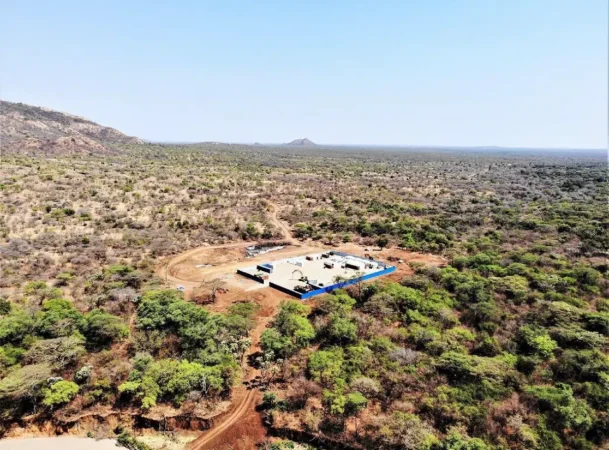 Aerial view of a remote mine camp in african bushland during electrical delivery